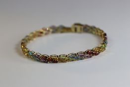 A Multi Gem Set Line Bracelet set throughout with marquise shaped amethyst, blue topaz, peridot,