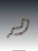 An Amethyst and 9 Carat Yellow Gold Line Bracelet set with seven circular mixed cut amethysts,