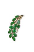 A vintage floral bright emerald green jadeite brooch in yellow gold mount