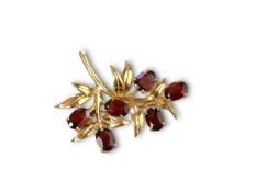 A garnet and yellow gold brooch, mounted in 9ct gold