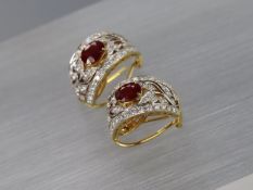 A pair of oval-shaped ruby ear clips, approximate 3-4 carats