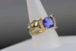 A tanzanite and diamond ring mounted in 14kt gold