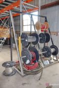 Rack with spools of cables and hose