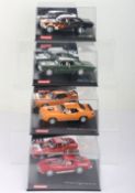 Four boxed Carrera Evolution slot cars,