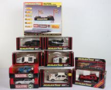 Eight boxed Scalextric slot cars,
