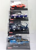 Four boxed Carrera Evolution slot cars,