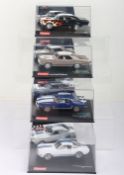 Four boxed Carrera Evolution slot cars,