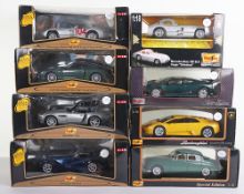 Eight boxed Maisto 1:18 scale model cars,