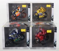 Four boxed Scalextric Moto GP slot motorbikes,