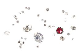 A GROUP OF LOOSE DIAMONDS AND A RED STONE