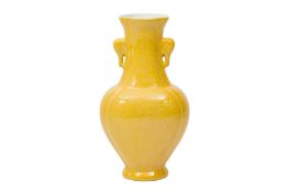 A CHINESE YELLOW-GLAZED TWIN-HANDLED VASE