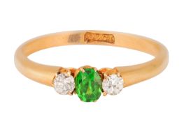 A THREE-STONE DIAMOND AND GARNET RING