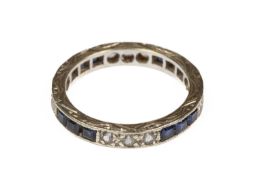 A sapphire and imitation diamond eternity ring
