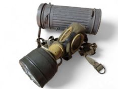 A WWII era German gas mask, in green canvas with s
