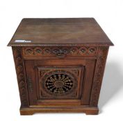 A square stained oak cupboard, the single carved d