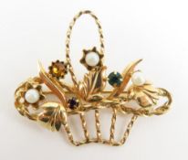 A contemporary stone set brooch in the form of bas