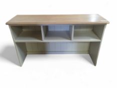 An off white painted bench, with light oak top, wi