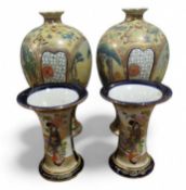 A pair of Japanese baluster vases, decorated in co