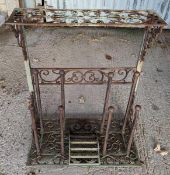 A decorative metal boot stand, with incorporated b