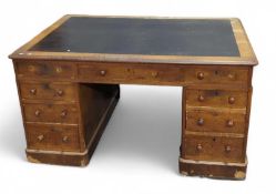 An early 20th century oak twin pedestal desk, a ba