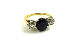 An 18ct gold sapphire and diamond three stone ring