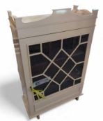 A cream painted cupboard, with a single astragal g