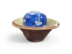 A large glazed terracotta cream crock, 50cms diameter