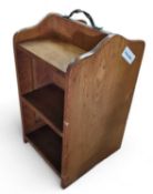 An oak low bookcase with shelves to either side an