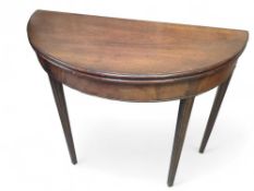 A mahogany demi lune fold over tea table 82.5cms h