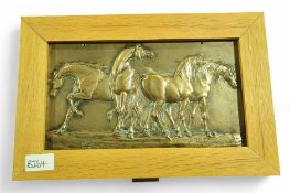 A heavy brass panel cast with horses, in wood fram