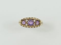 A 9ct amethyst and white stone ring, with beaded e