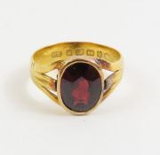 A 22ct gold band ring set with an oval facetted ga