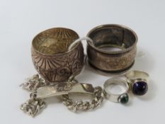 Two silver napkin rings, two silver rings each wit