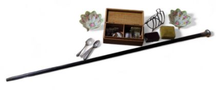 A silver four division toast rack, a silver napkin