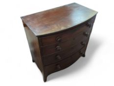 A 20th century oak bow fronted chest of four long
