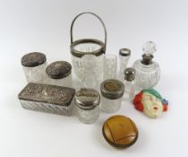 A collection of silver topped and cut glass dressing pots, including scent bottles