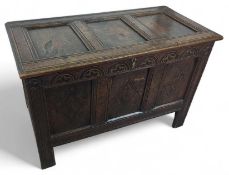 A 20th century large carved stained oak coffer, 77