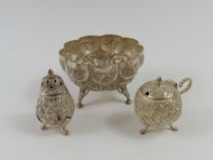 A white metal lobed bowl, with embossed decoration