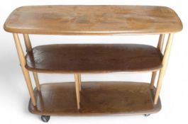 An Ercol bi-directional bookshelf of three shelves