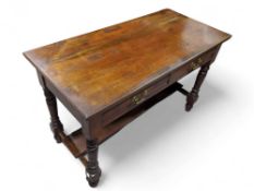An Edwardian red walnut side table fitted with two