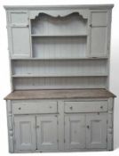 A pine dresser with white painted front, with two