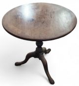A circular oak table with folding top, with turned