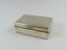 A silver box with wooden interior, made by an undi