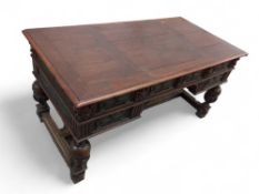 A large stained oak desk with embossed metal panel