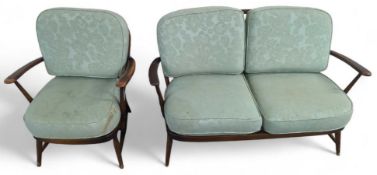 A dark Ercol two seat sofa with pale green cushion