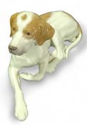 A Royal Copenhagen figure of a hound lying down, 1