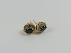 A pair of 9ct gold sapphire and diamond cluster st