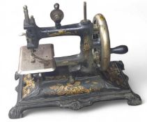 A small 19th Century sewing machine on decorative