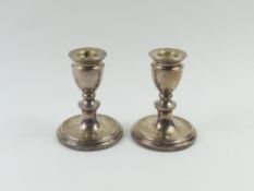 A pair of contemporary squat silver candlesticks, 10cm high (filled)