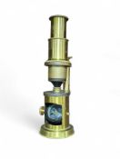 An early 20th Century brass pocket microscope in w